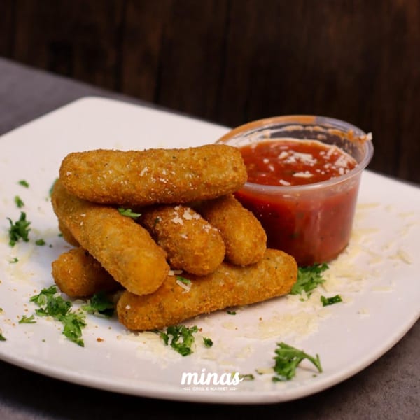 Golden-brown mozzarella sticks with grated cheese and parsley, served with a side of marinara sauce.